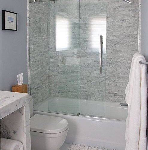 sliding glass shower door in white bathroom