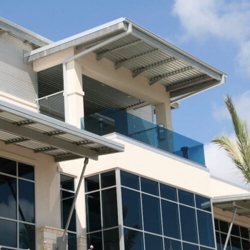 Exterior View of Glass Railing & Curtain Wall System on Building | J&J Worldwide | Commercial Projects | Anchor-Ventana