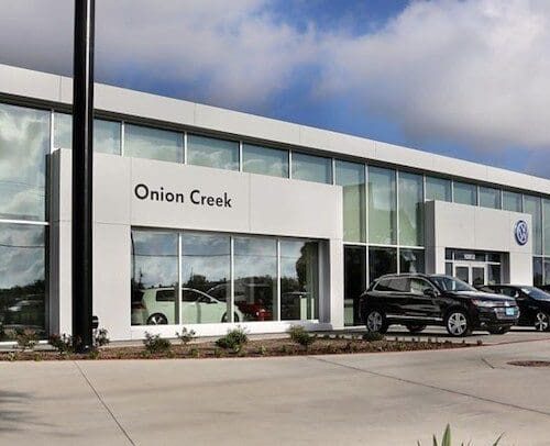 Exterior View of Glass Curtain Wall System & Storefront Entrance | Onion Creek Volkswagen | Commercial Projects | Anchor-Ventana Glass