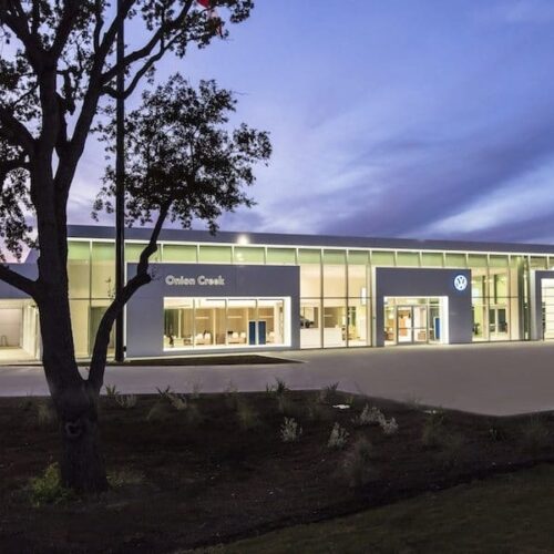 Exterior View of Glass Curtain Wall System & Storefront Entrance | Onion Creek Volkswagen | Commercial Projects | Anchor-Ventana Glass