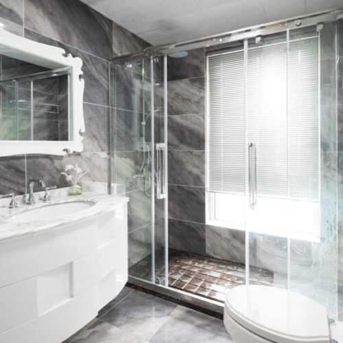 sliding glass shower door in grey bathroom | shower door styles