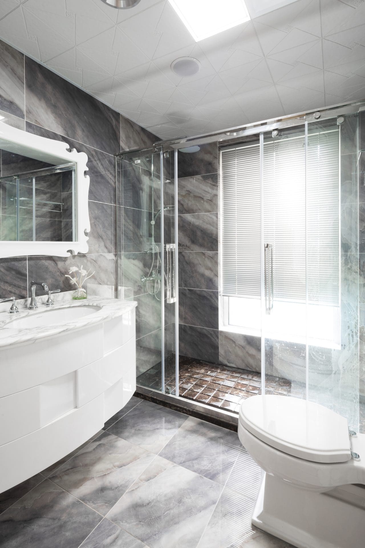 sliding glass shower door in grey bathroom