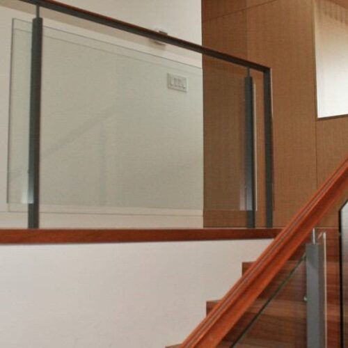 Custom Glass Handrail with Standoff Hardware in Stairway | Commercial Glass Handrails | Commercial Products | Anchor-Ventana Glass