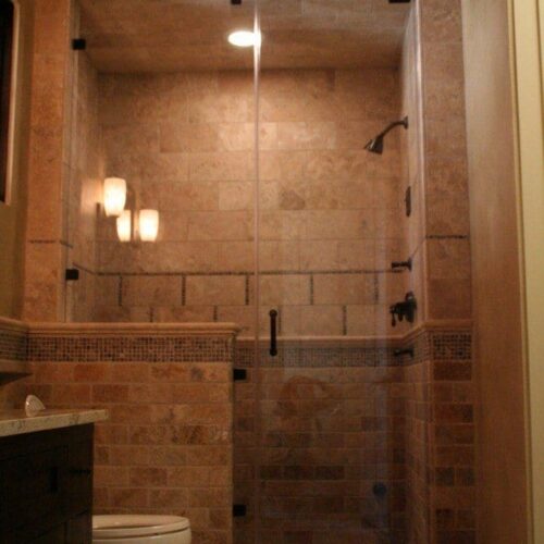 Frameless Inline Steam Enclosure with Pivots on Door and Clamps on Notched Panel in Bathroom Shower | Shower Gallery | Anchor-Ventana Glass